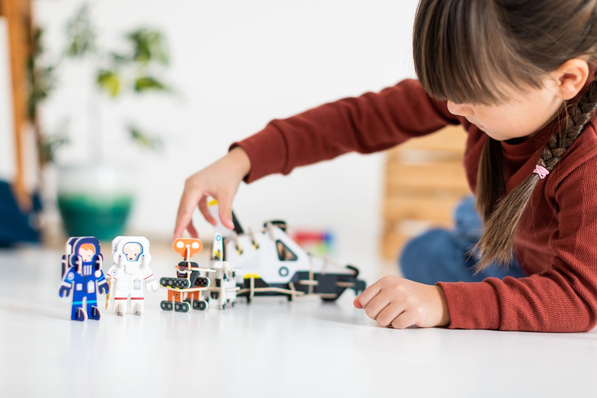 A child playing on the floor with Playpress pocket money toys