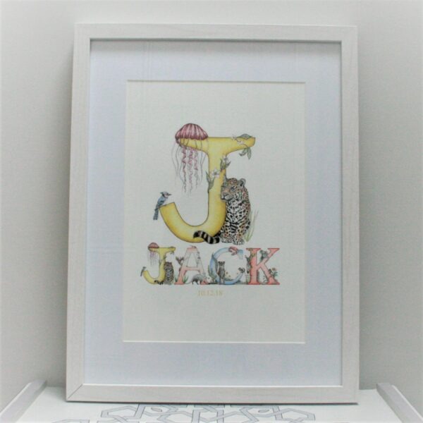 A framed personalised name print showing the name Jack. All letters feature animals and plants beautifully illustrated.