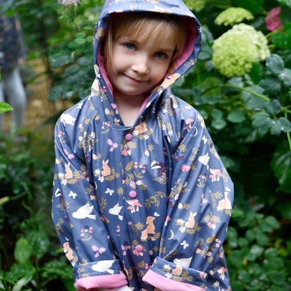 Little girl wearing our Enchanted Forest raincoat for children. Shop online with Ebb & Flow Kids