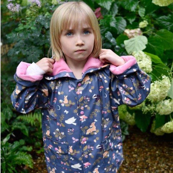 Little girl wearing our Enchanted Forest raincoat for children. Shop online with Ebb & Flow Kids